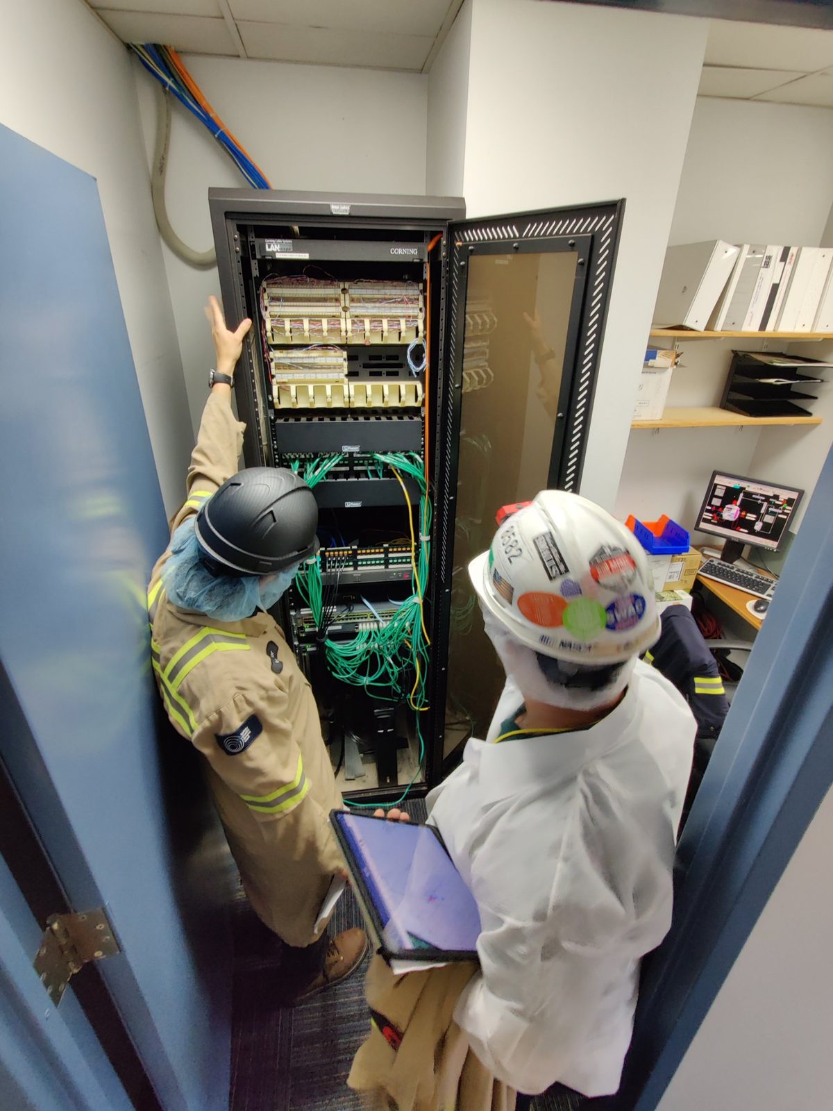 DES technicians at work on a network rack