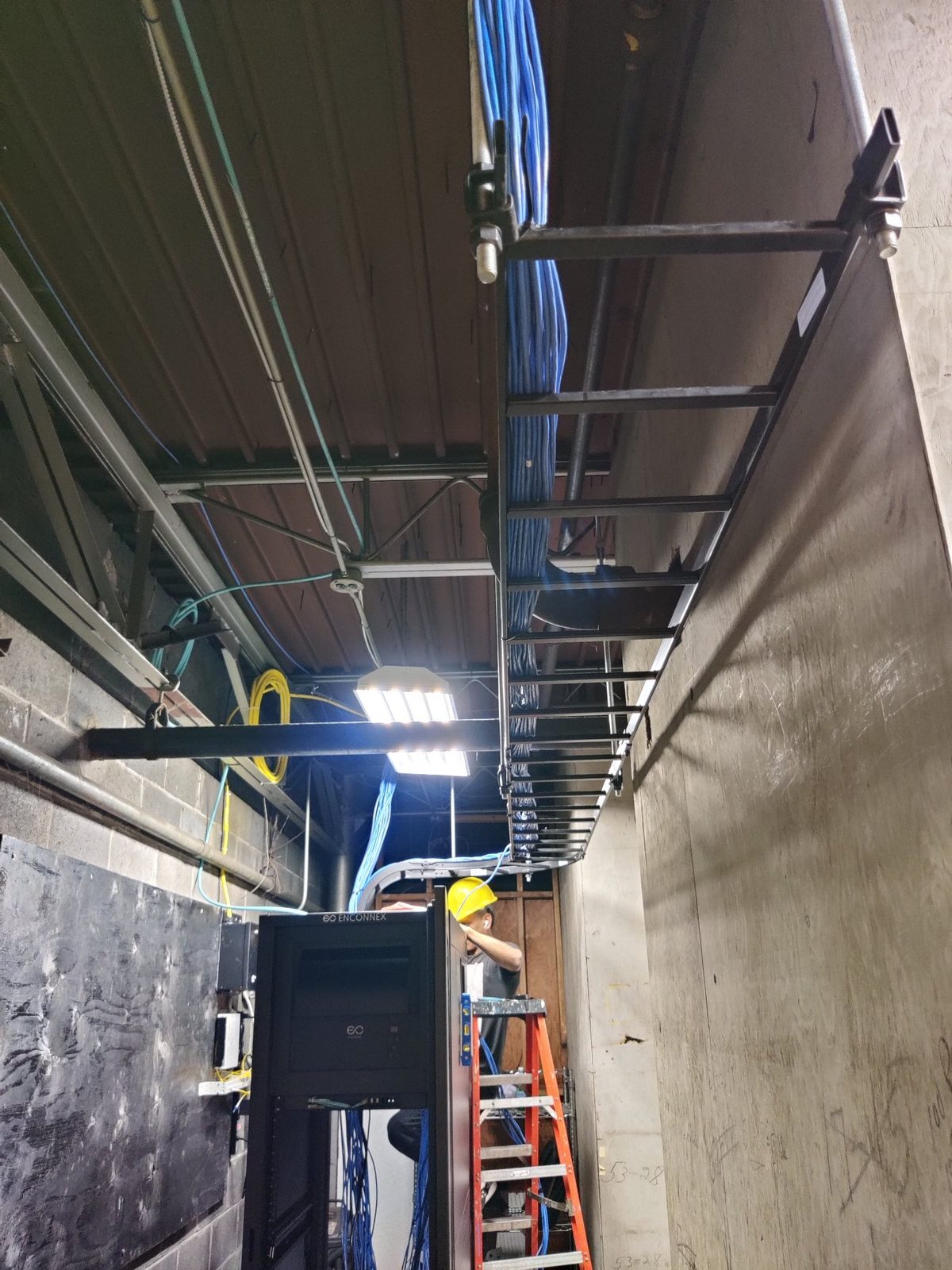 Technician installing cable tray